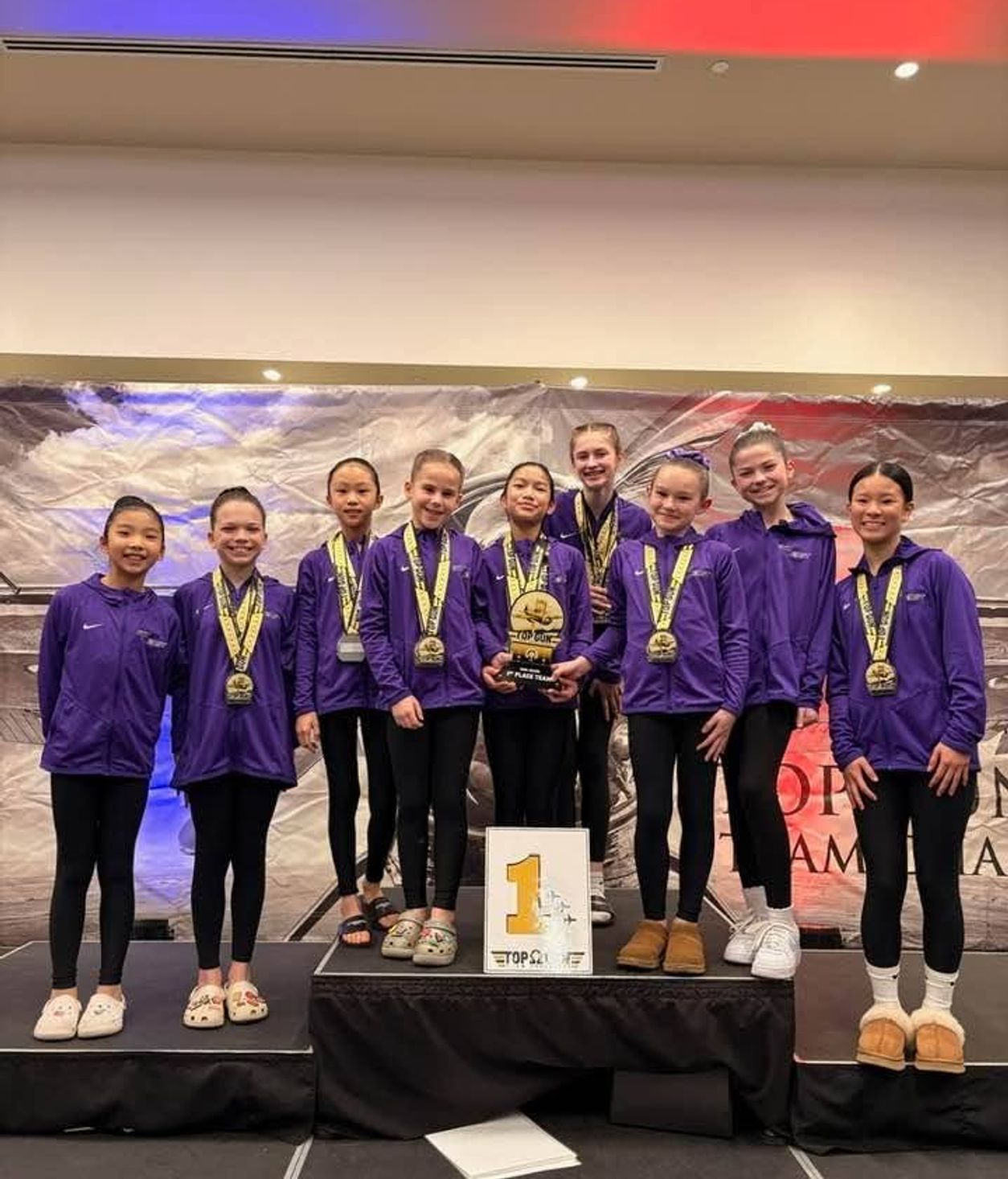 Gymnastics East athletes celebrating with medals