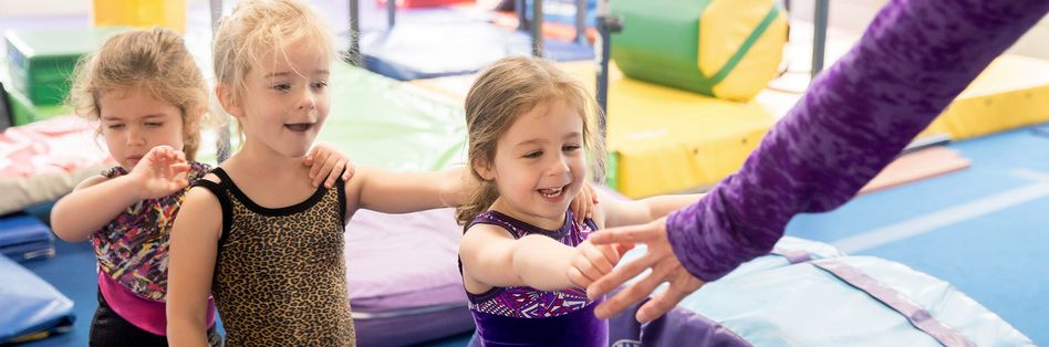 Children learning gymnastics skills in class