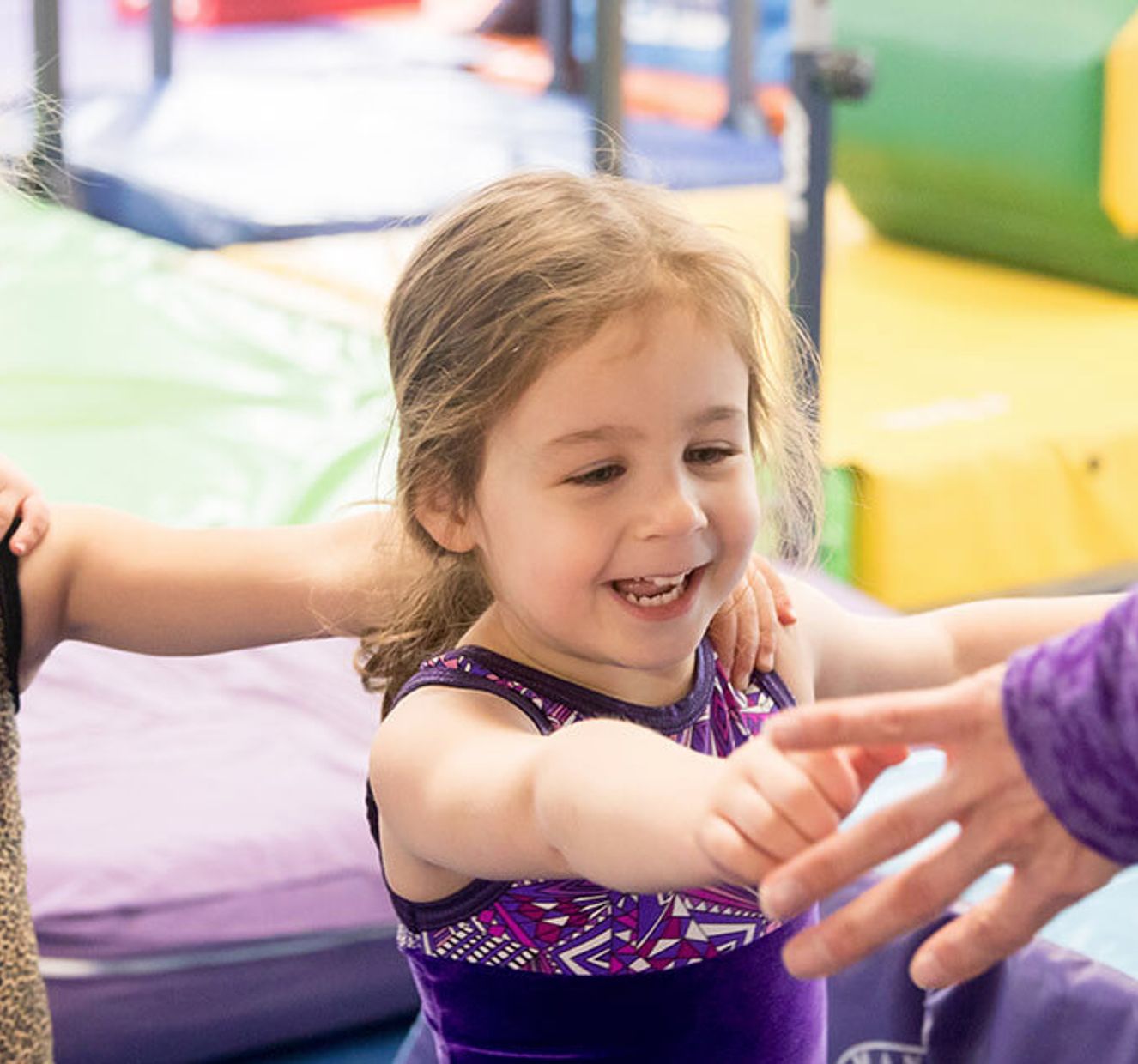 Gymnastics East students practicing skills in class