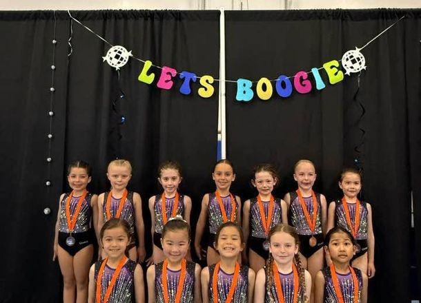 Young Gymnastics East athletes posing with medals