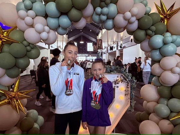 Gymnastics East athletes showing medals at a gymnastics meet