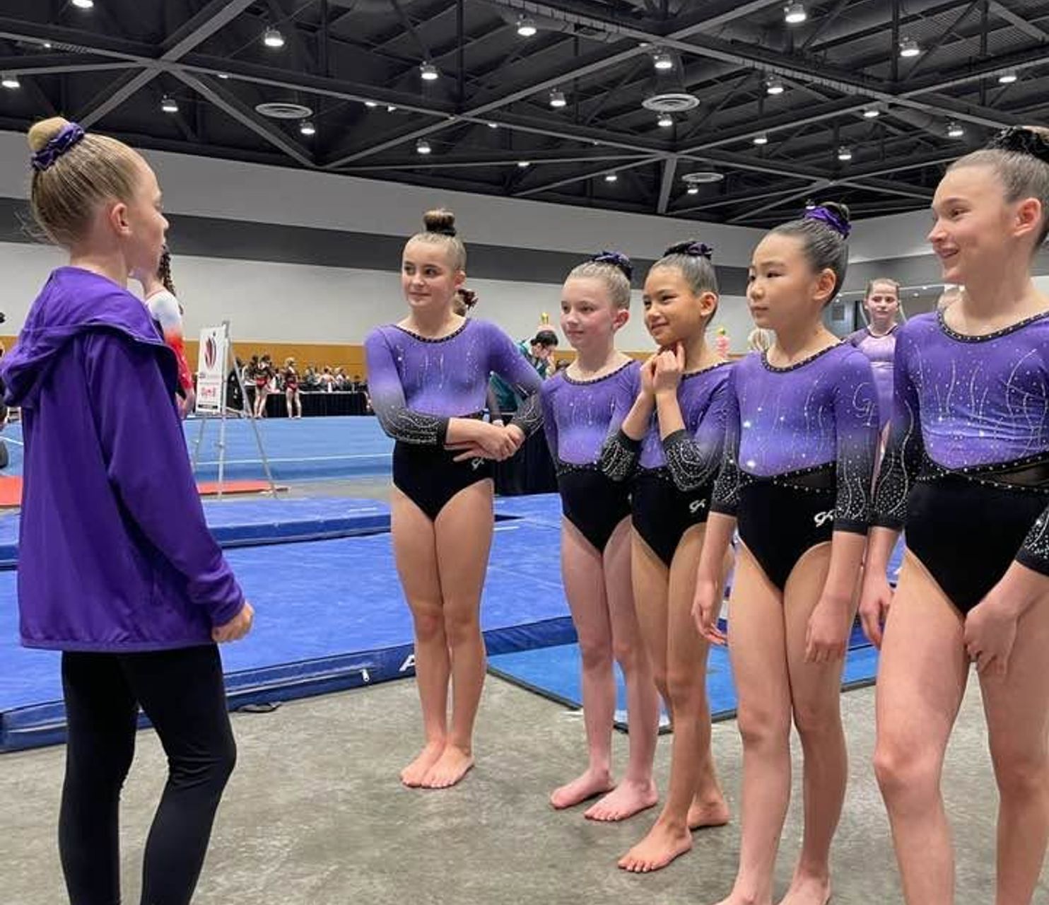 Gymnastics East coach talking with athletes