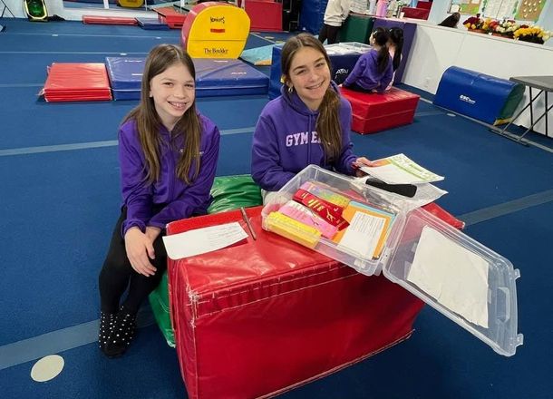 Gymnastics East athletes preparing equipment together